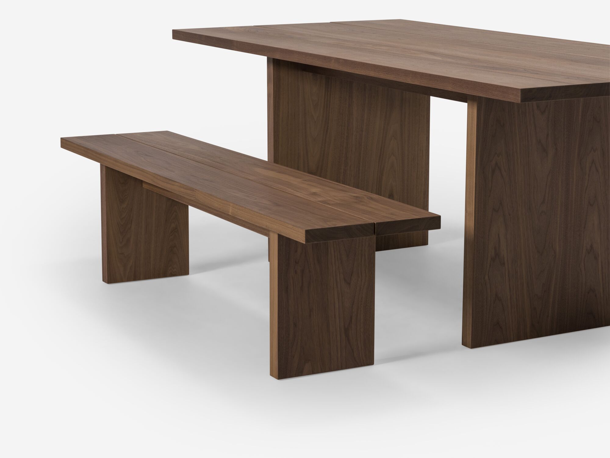 Walnut dining bench and matching table detail view